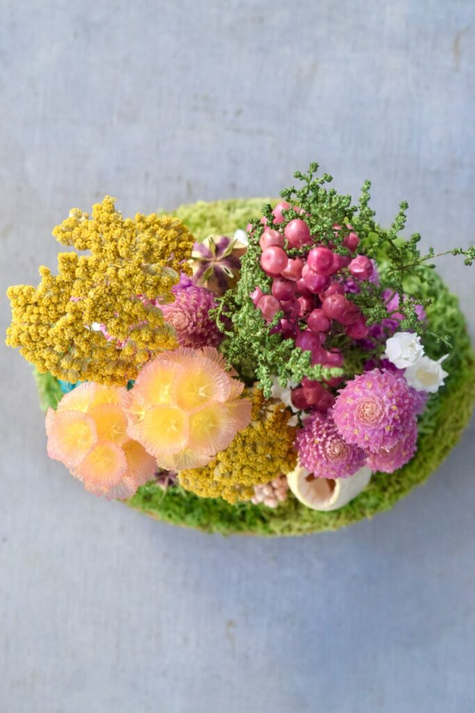 東京の花屋『叢屋kusamuraya』が手がける、手のひらにおさまるフォルムが可愛らしい植物インテリア。瑞々しいグリーンとウッドプレートの温もりが感じられる、ナチュラルなひと品。